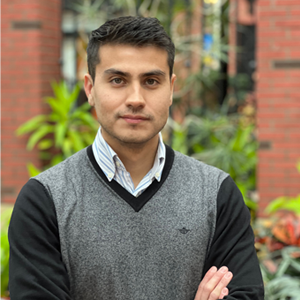 Photograph of Fernando Rojas standing outside.